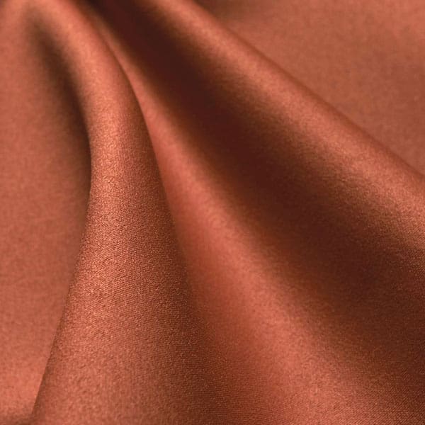 Close-up of Spectrum Terracotta contract fabric sample for care home interiors